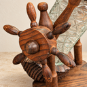 Close-up of the nautical bottle holder's wooden ship-wheel hub, handles and turned support.
