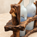 Close-up of the rope knot, wooden post and textured edge of the rustic double-bottle holder.